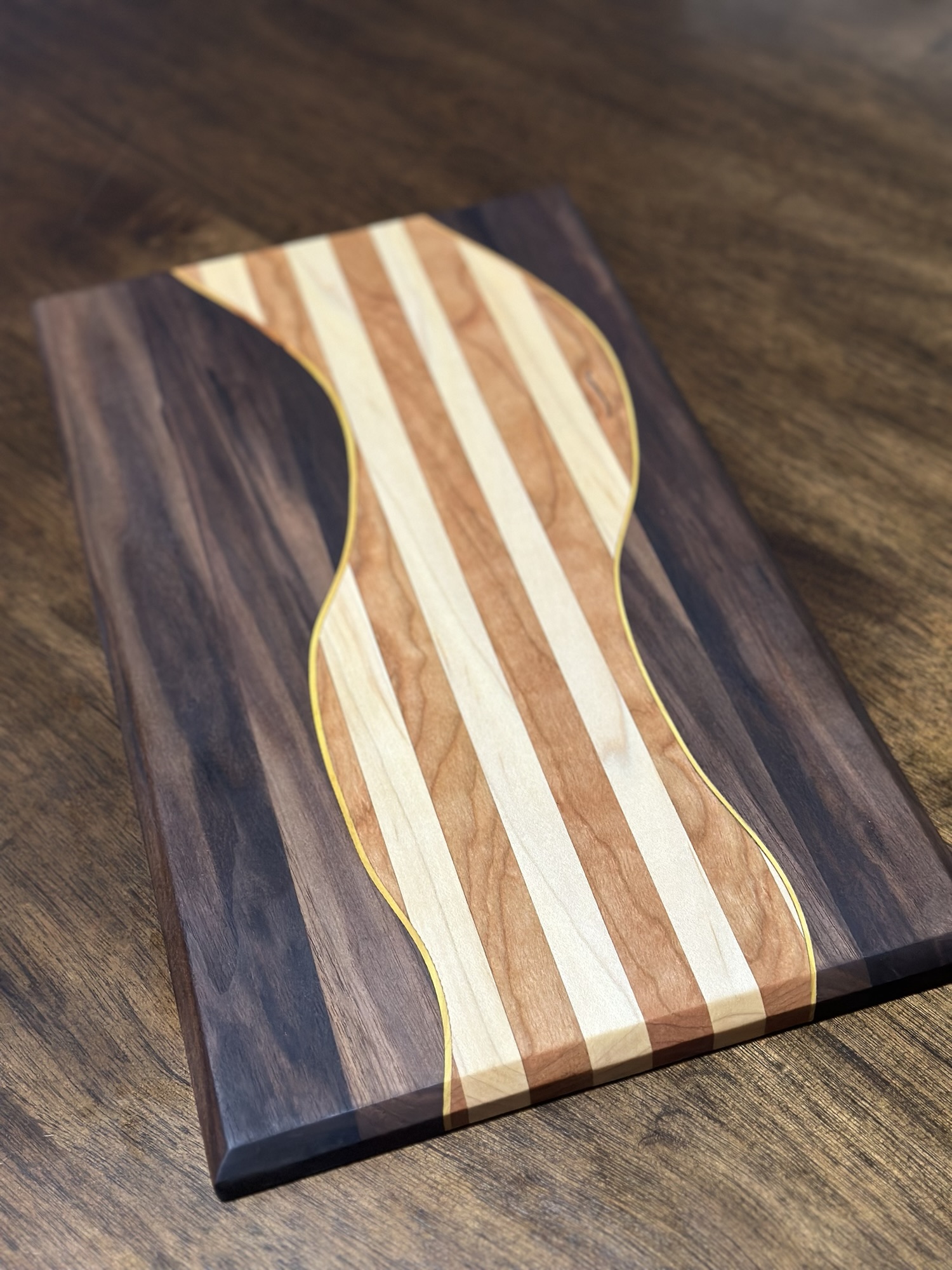 Multi-wood curved board